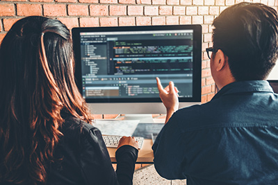 Web design Ocean County professionals reviewing a screen of code